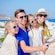 A family posing as the dad holds a camera on a selfie stick